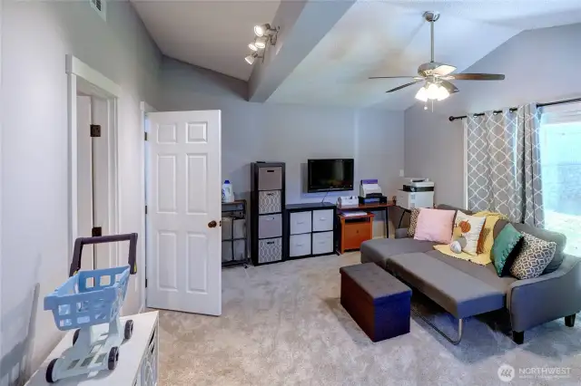 Bonus room with ceiling fan, attached 3/4 bathroom, laundry room and access to covered patio area through the sliding glass door. Could be used as a 4th bedroom, guest room, den, rec room, office or hobby room.
