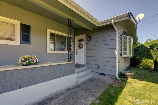 The covered front porch with planter box greets you before entering this beautifully remodeled home.