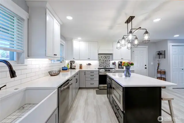 You will enjoy preparing your meals in the recently remodeled kitchen. Quartz counters, island with eating space. Built-in microwave, gas range, farm-style sink, soft-close shaker cabinets, stainless steel appliances.
