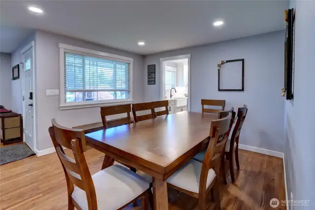 The living room is open to the dining space and front entry.