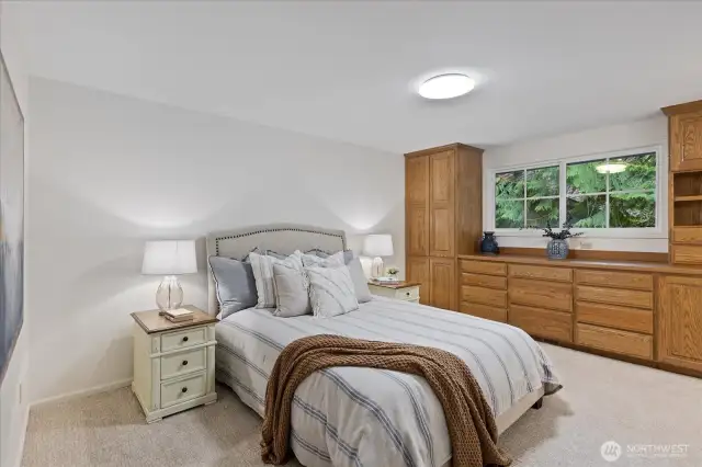 Primary bedroom with custom built-in closets.