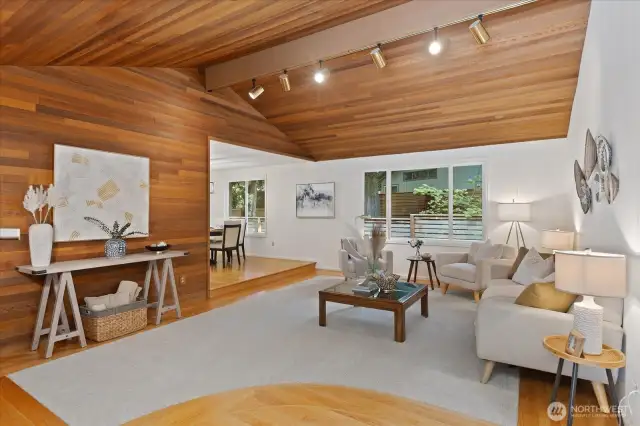 Vaulted ceilings in formal living room leading to dining room.