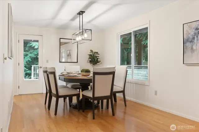 Dining room with access to expansive wooden deck and private garden.