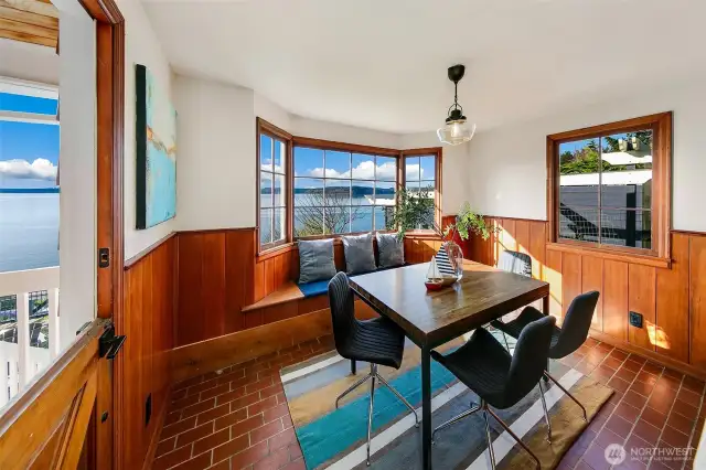 Wrapped in tongue-and-groove paneling and steeped in natural light, this inviting dining room captures the essence of Pacific Northwest living. The Dutch door opens to sea air and soundscapes, while windows frame horizon-spanning views from Browns Point to the Olympics. A place to gather, reflect, and watch the tide roll in.