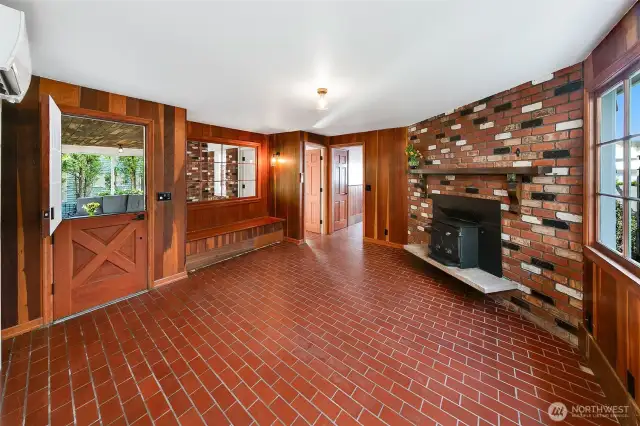 With its original brick floors, warm wood walls, and a whimsical fireplace that mirrors the home’s entry, this versatile room invites creativity. Once a gathering space, studio, or second living area, it opens to the sea breeze through a storybook Dutch door—ready to host, retreat, or transform to meet your vision above Caledonia Cove.