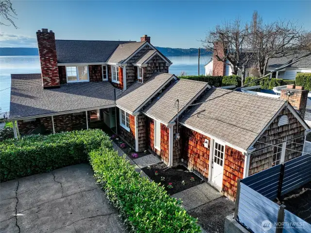 A rarity in Browns Point, this upland estate offers generous off-street parking both at the home and in a shared upper court—ideal for guests, boat storage, or everyday ease. A level path leads directly to the front door and main-floor bedroom, offering a thoughtful layout that supports universal access, multigenerational living, or aging in place—all without compromising charm or view.