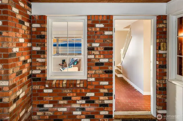 A playful mosaic of mid-century brick greets you just inside the covered entry—a signature detail of this 1964 Cape Cod. Through the threshold, warmth and light spill from the heart of the home, where original character meets endless potential. Each corner of this Caledonia Cove retreat hints at a legacy of craftsmanship and a future full of possibility.