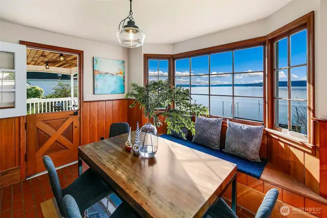 With salt-kissed breezes drifting through the Dutch door and sunlight pouring across handcrafted millwork, this waterside dining space is both grounding and expansive. Panoramic windows frame the Salish Sea like living art, while the built-in banquette invites slow mornings, long lunches, and sunset suppers in true Browns Point style.