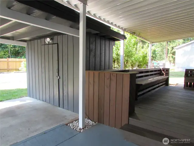 COVERED AREA INCLUES LARGE DECK W/ SEATING TO RIGHT.