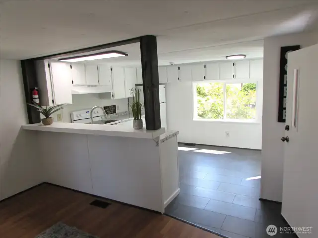 UPDATED, FLOORING & LIGHTING & PAINT T/O. FRONT KITCHEN W/ DINING AREA.
