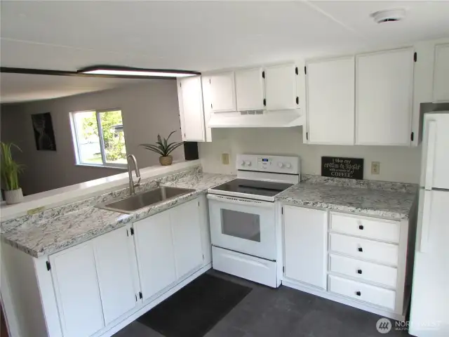 NEW COUNTERS, UPDATED CABINETS/ APPLIANCES, OPEN BAR FACES LIVING ROOM.
