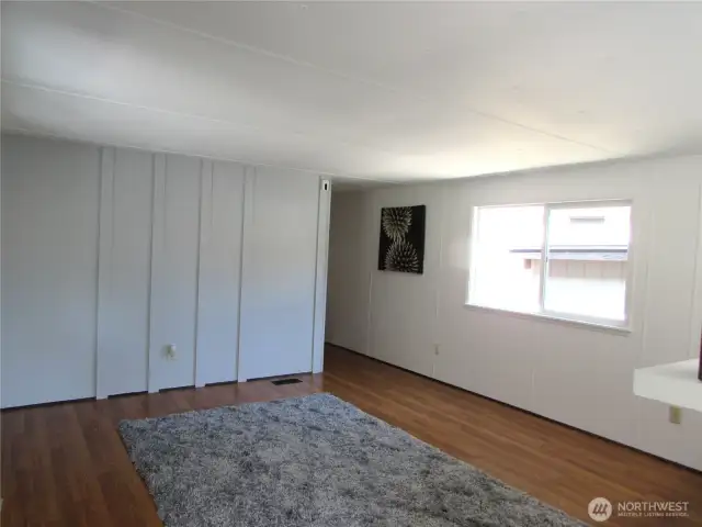 LIVING ROOM W/LAMINATE FLOORING, NEW INTERIOR PAINT.