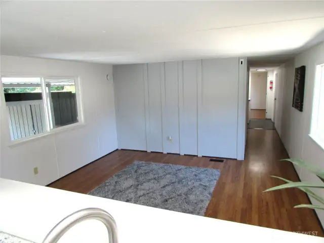 HALLWAY TO BEDROOMS/ BATH, PRIMARY BEDROOM AT END NEXT TO BATHROOM, WASHER/DRYER & BACK DOOR.