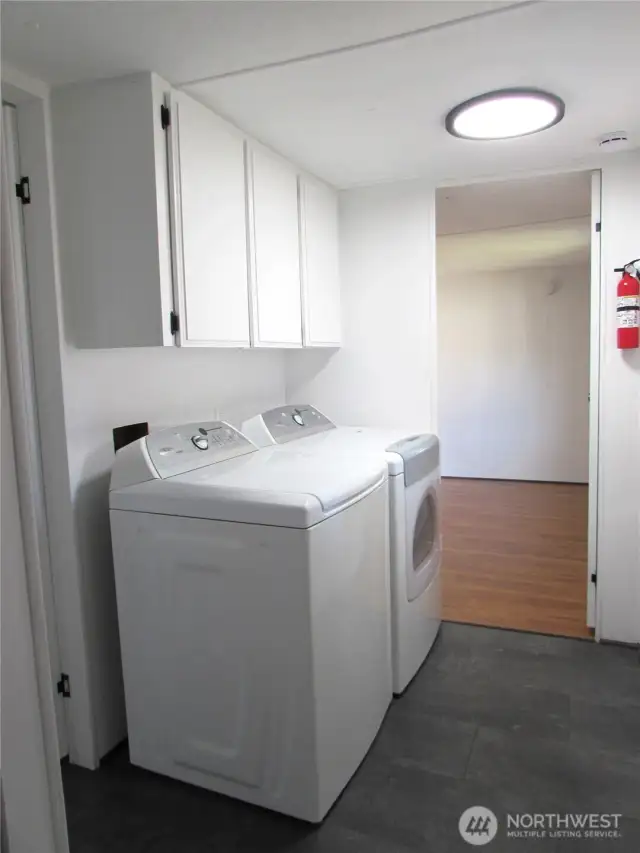 LAUNDRY AREA HAS OVERHEAD STORAGE NEXT TO PRIMARY BEDROOM ENTRY. APPLIANCES STAY WITH HOME.