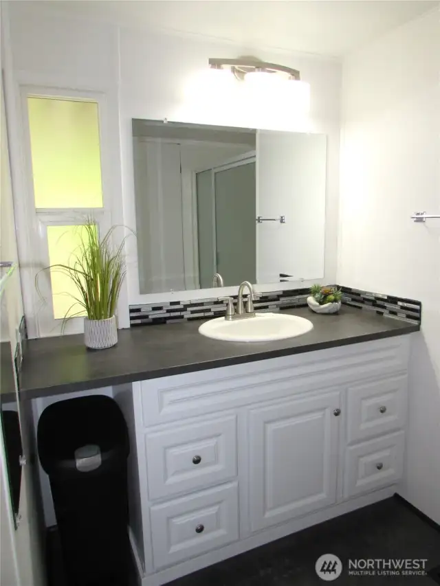 REMODELED BATHROOM GIVES MODERN FEEL, HAS A WALK-IN SHOWER.