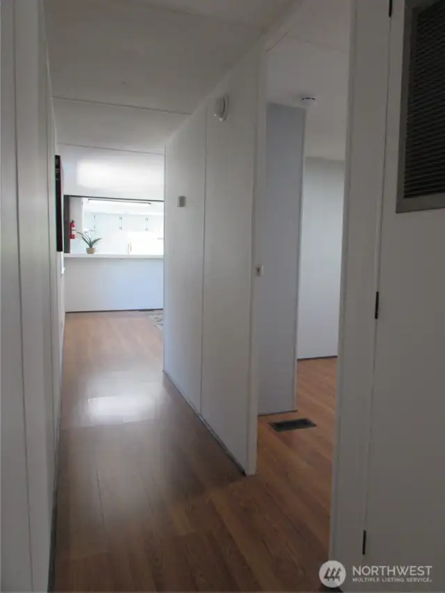 WALKING BACK TOWARD LIVING ROOM.