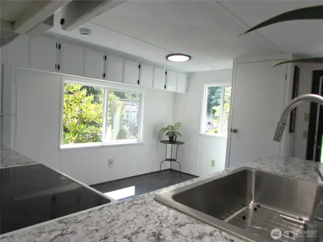 NEW KITCHEN COUNTERS, SINK, FAUCET & APPLIANCES. DINING AREA WINDOW FACES SOUTH AND EAST.