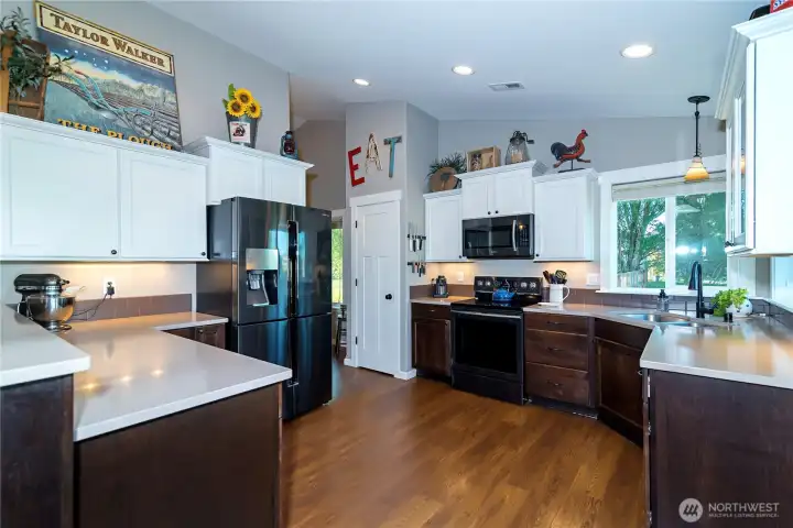 Spacious counters, quartz counters & undermount lighting make this kitchen a great place to be