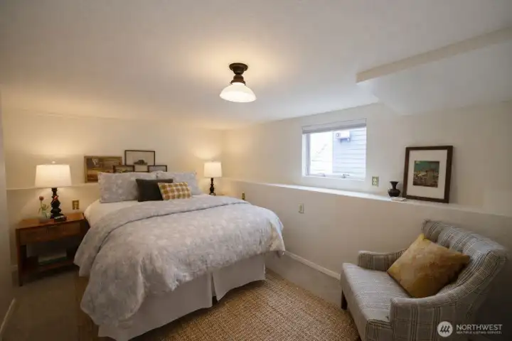 Lower level primary bedroom is cozy in winter and cool in summer.