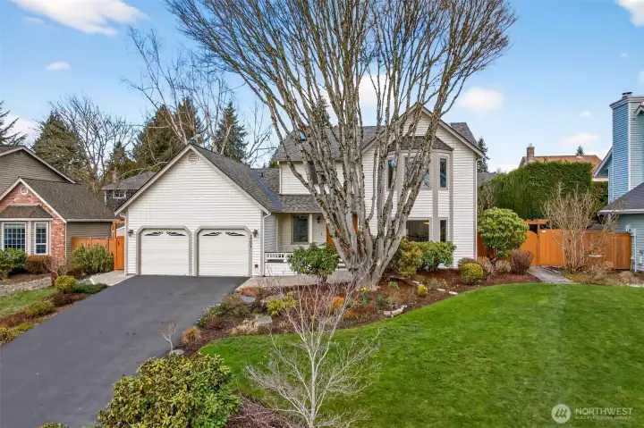 Clean curb appeal and a functional approach, including a deep driveway and a two car garage that makes daily parking and storage easy. Established plantings and a generous front lawn create a polished arrival.
