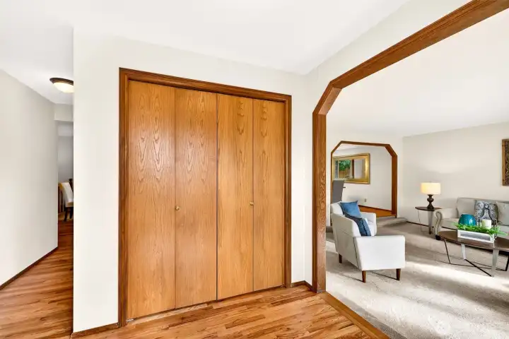 A practical entry with updated flooring (2026) and a spacious coat closet for everyday organization. The arched opening creates a graceful flow into the main living spaces.