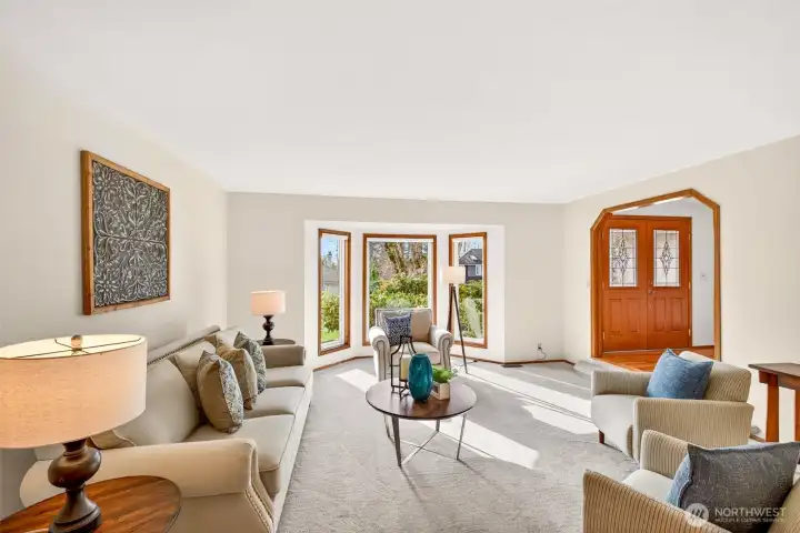 A bright, open living area that connects naturally to the rest of the main level, making entertaining and daily living feel effortless. Clean lines and thoughtful openings keep the space feeling airy and connected.