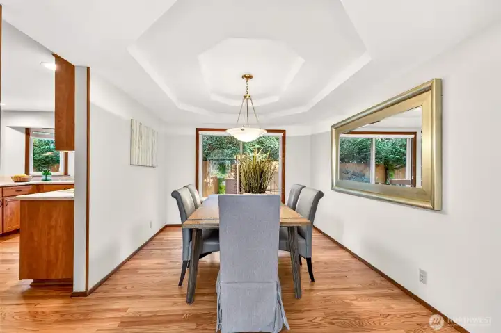 Dedicated dining space with a tray ceiling detail that adds character without feeling formal. A large window invites nature inside, creating a tranquil dining area for hosting or weeknight meals.