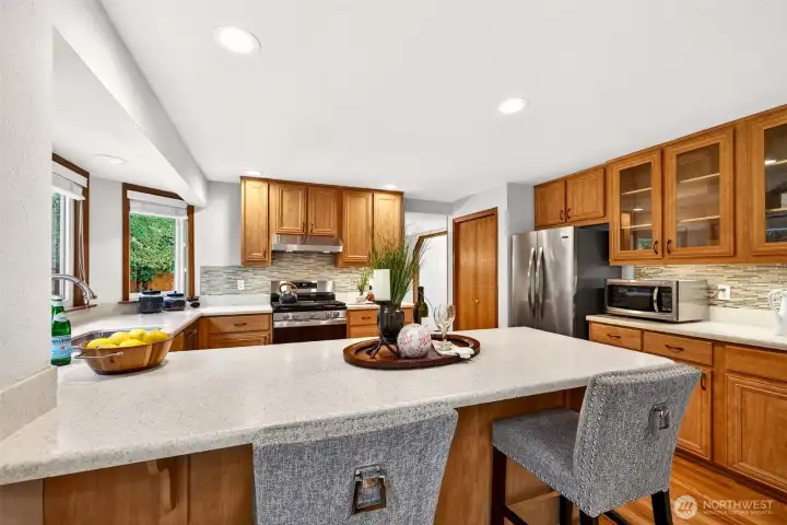 A welcoming gathering hub anchored by the large peninsula and a well planned cooking zone with a gas range and stylish backsplash. Updated appliances add confidence and convenience for day to day living.
