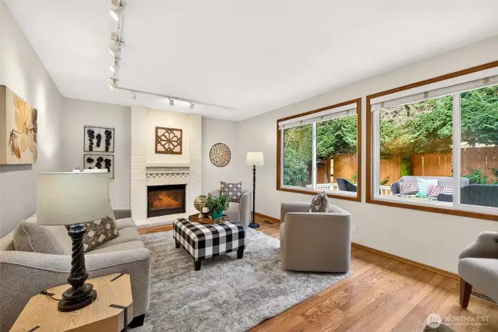 Comfortable main level family area with a classic fireplace focal point and large windows that bring in natural light and backyard views. Track lighting adds flexibility for art, displays, or accent lighting.
