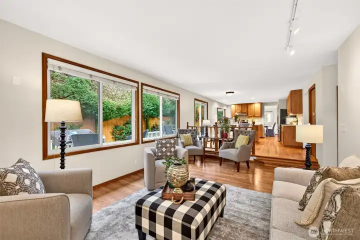 Spacious family room with an open connection back to the kitchen and dining areas, making the layout feel expansive and practical. Generous windows invite in natural light and create a peaceful outlook to the yard.