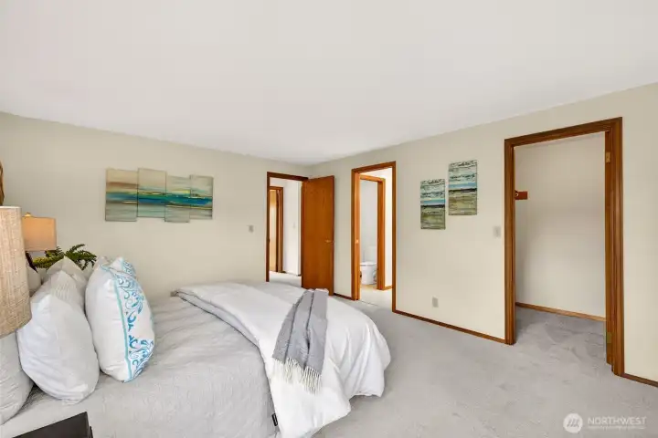 A generous primary suite with soft carpeting and plenty of floor space for a king size layout, plus extra room for a sitting area or workspace. The adjoining bath and walk in closet create a true retreat feel.