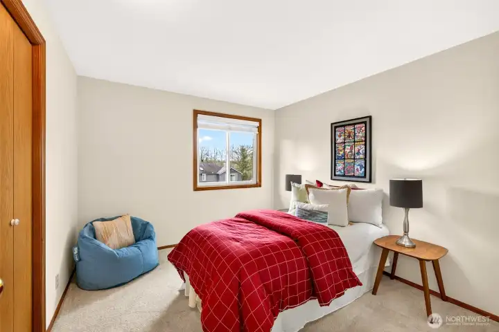 Light filled upper level bedroom with multiple windows and a generous footprint that allows for a variety of layouts. A comfortable space with a pleasant outlook and room to personalize.