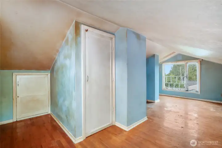 Upstairs room with closet and access to unfinished attic space