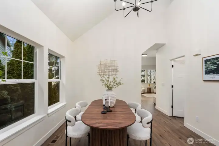 Dining room has huge tall ceilings and spacious room for a big table