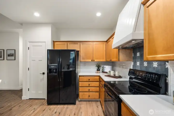 Nice kitchen with brand new quartz countertops with a stylish hood.