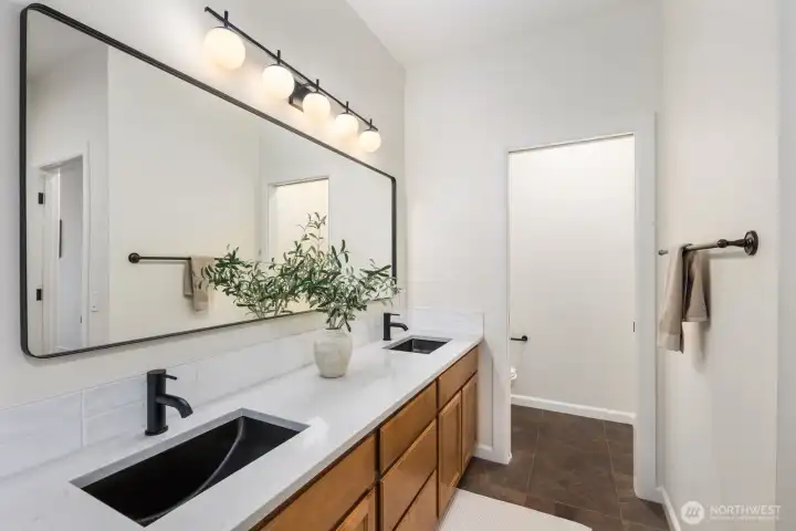 5 piece double vanity bathroom with a private door for toilet