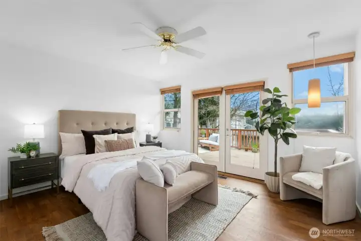 The primary suite provides a peaceful retreat with French doors leading to the deck, an updated bath, and walk-in closet