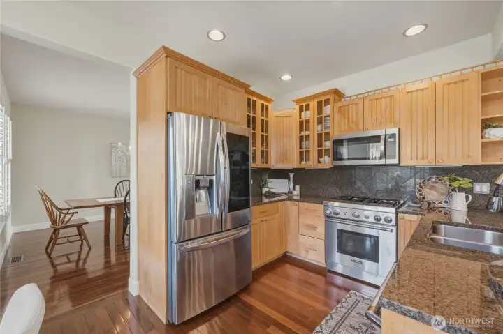 The kitchen features a Thermador range and new microwave, dishwasher and newer refrigerator. Granite countertops and lots of storage!