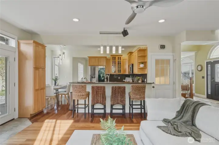The eat in kitchen and breakfast bar open to the family room. Access to the lower level apartment is pictured here as well.