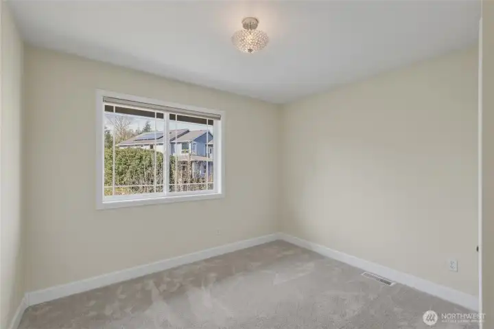 Guest bedroom #2 faces the backyard and down the hallway from the primary suite.