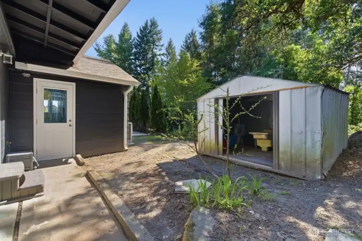 Door from laundry room. Keep or remove the shed for extra space.