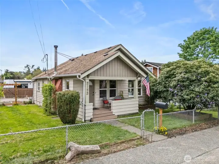 Inviting front exterior offers timeless character, established greenery, and a convenient location close to ferry access and PSNS.