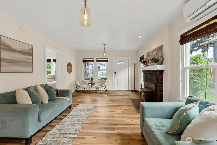 Spacious main living area blends timeless character with modern comfort, featuring a cozy wood stove and open flow.