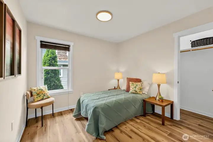 Comfortable bedroom with updated flooring, abundant natural light, and closet space for easy living.