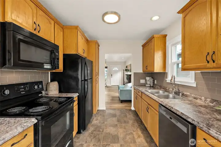 Spacious galley-style kitchen offers abundant cabinetry, ample prep space, and an efficient functional layout.
