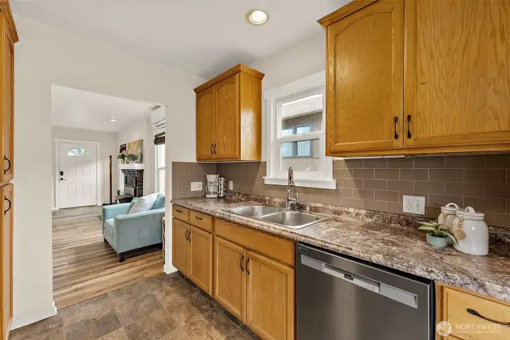 Bright kitchen features durable finishes, plentiful storage, and easy flow into the main living spaces.