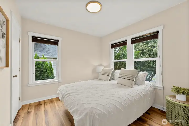 Peaceful bedroom retreat with updated flooring, oversized windows, and a bright airy feel throughout.