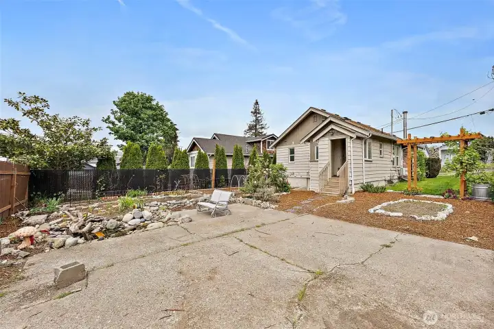 Expansive backyard with large patio area, established gardens, and plenty of room for gatherings, hobbies, or future possibilities.
