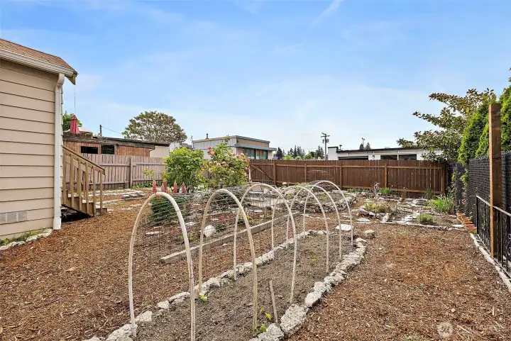 Established garden beds and thoughtfully landscaped grounds create a peaceful outdoor oasis with space to grow and entertain.