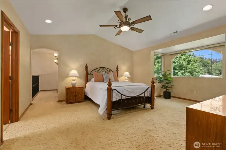 Primary bedroom with views of the property, Romeo and Juliet balcony, walk-in closet and en suite bathroom.